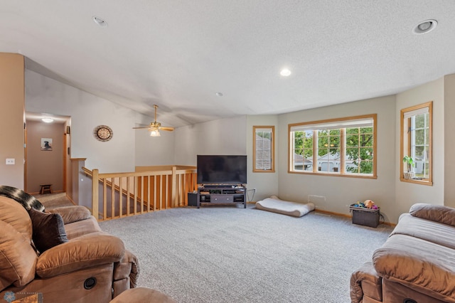 living room with vaulted ceiling, a textured ceiling, and carpet flooring