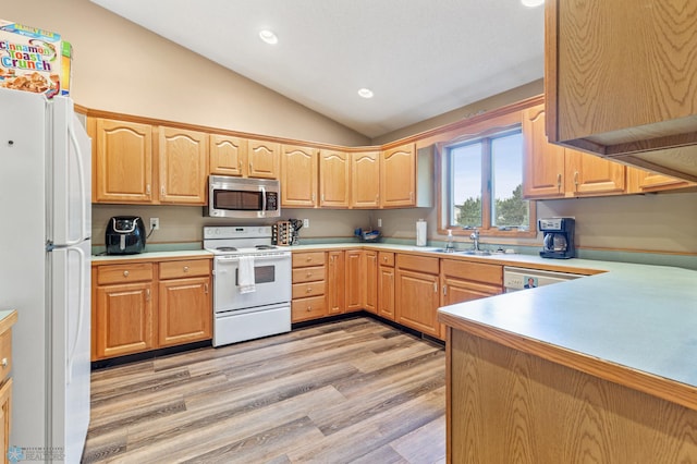 kitchen with white appliances, light wood-type flooring, lofted ceiling, light brown cabinetry, and sink