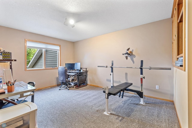 carpeted office space featuring a textured ceiling