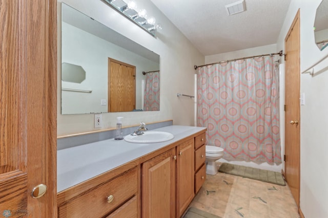 full bathroom with shower / tub combo with curtain, a textured ceiling, vanity, and toilet