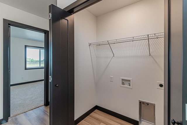 washroom with light wood-type flooring, electric dryer hookup, and hookup for a washing machine