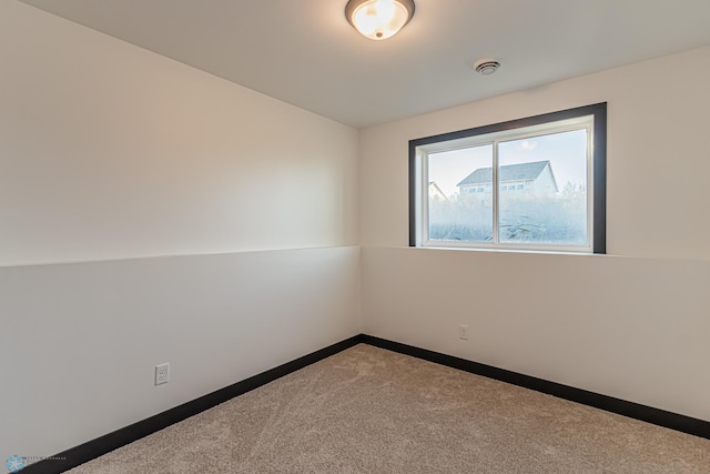 unfurnished room with lofted ceiling and carpet flooring