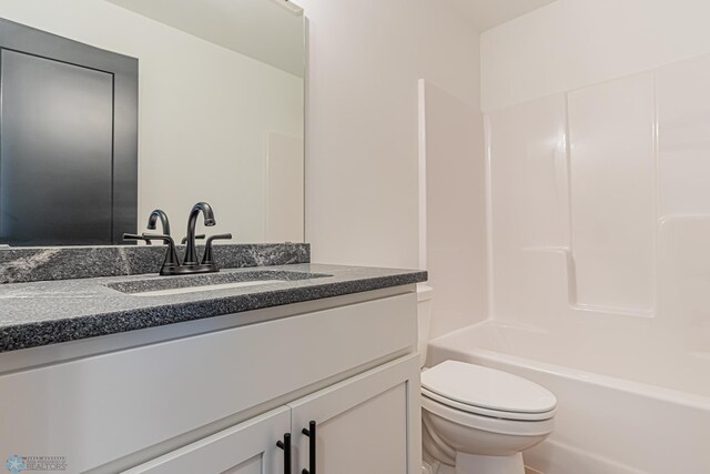 full bathroom featuring bathing tub / shower combination, vanity, and toilet