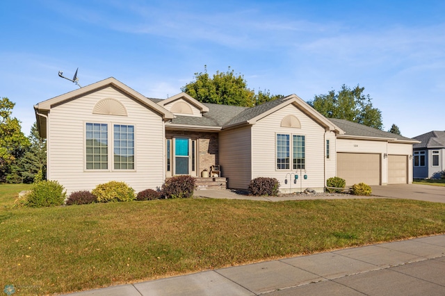 single story home featuring a front lawn and a garage