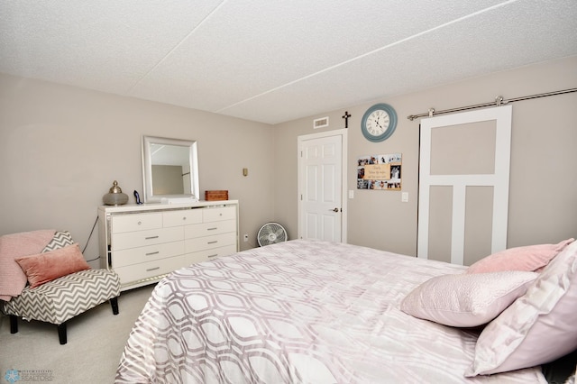 bedroom featuring carpet floors and a textured ceiling