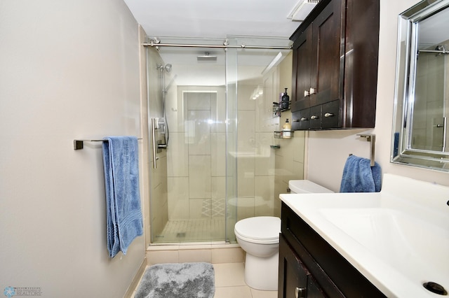 bathroom featuring tile patterned flooring, an enclosed shower, vanity, and toilet