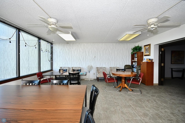 dining room featuring a textured ceiling, carpet flooring, and ceiling fan