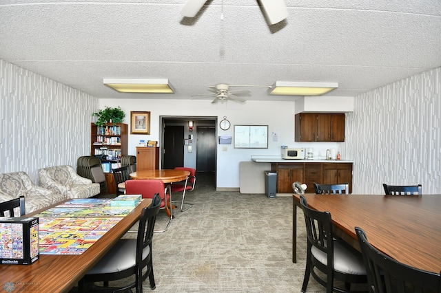 dining room featuring ceiling fan and a textured ceiling