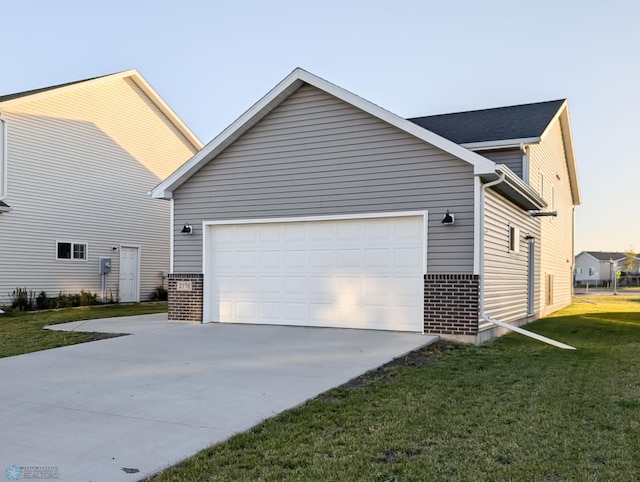 view of side of home featuring a lawn and a garage