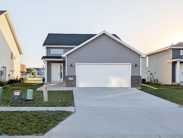 view of front of property featuring a garage and a lawn