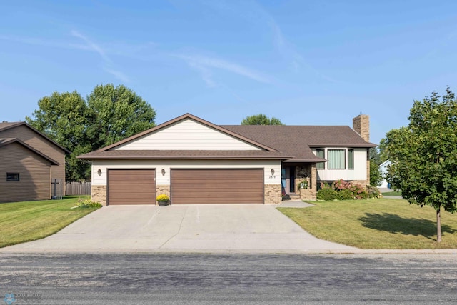 view of front of house featuring a front yard and a garage