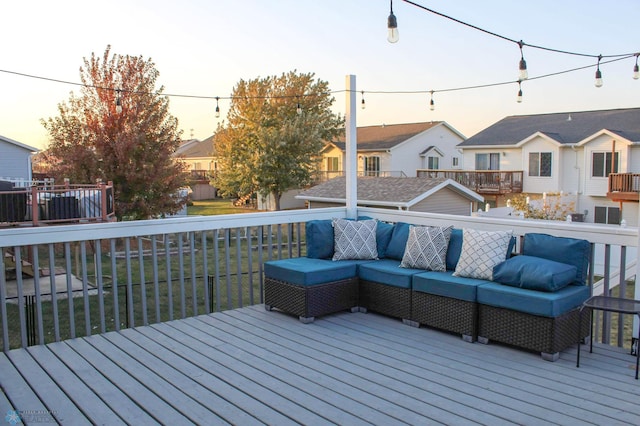 deck at dusk with outdoor lounge area