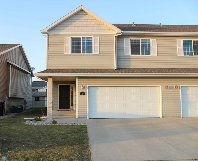 view of front of home featuring a garage and a front lawn