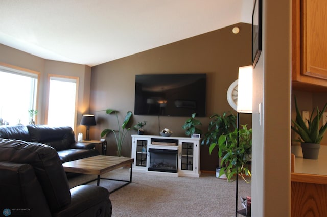 living room featuring vaulted ceiling and light colored carpet