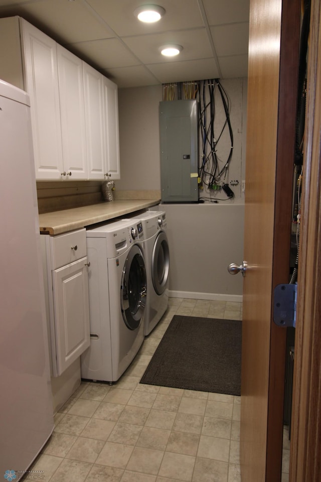 laundry room with separate washer and dryer, electric panel, light tile patterned floors, and cabinets