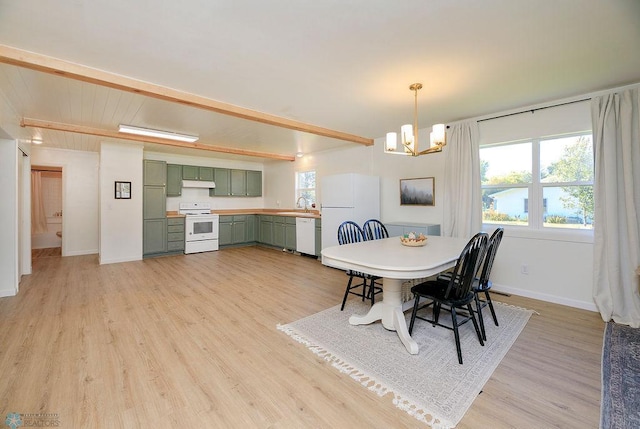 dining space with light hardwood / wood-style floors, sink, beamed ceiling, and a chandelier