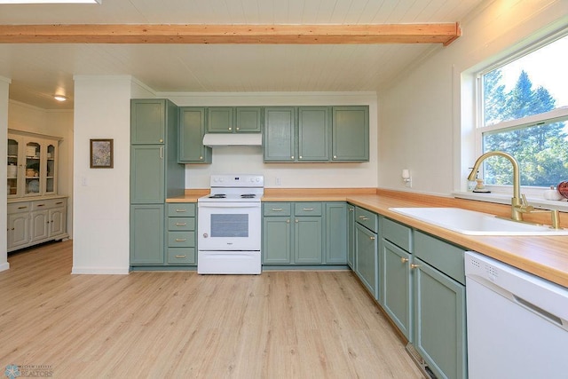 kitchen with beamed ceiling, light wood-type flooring, sink, and white appliances