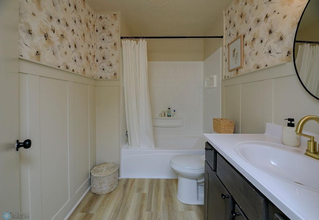 full bathroom with shower / bath combination with curtain, wood-type flooring, vanity, and toilet