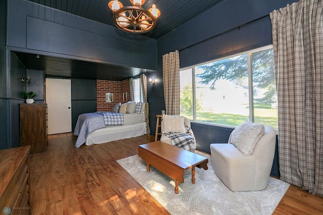 bedroom featuring a notable chandelier, wood-type flooring, and wooden ceiling