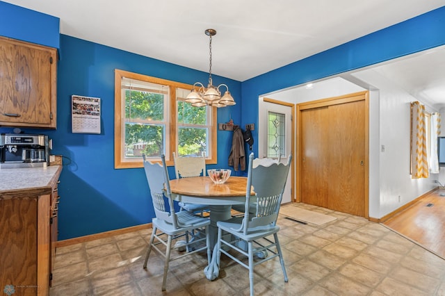 dining room with light hardwood / wood-style flooring and a chandelier