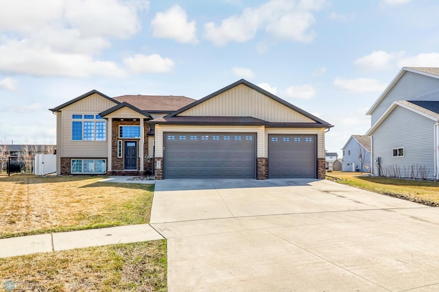 view of front of home featuring a front yard and a garage