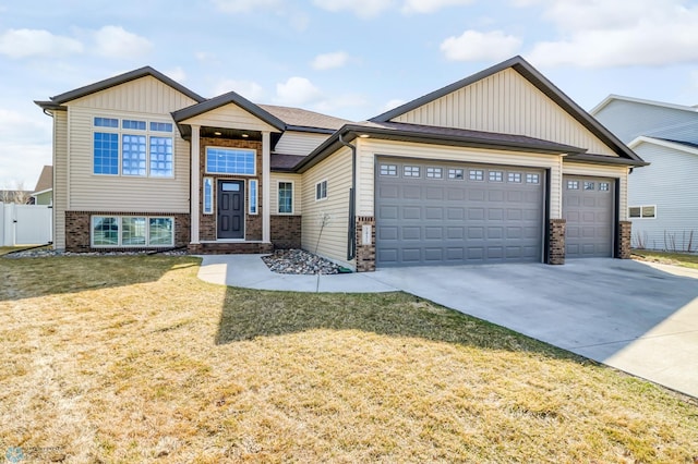 view of front of property with a front yard and a garage