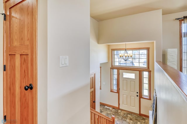 entryway with a chandelier