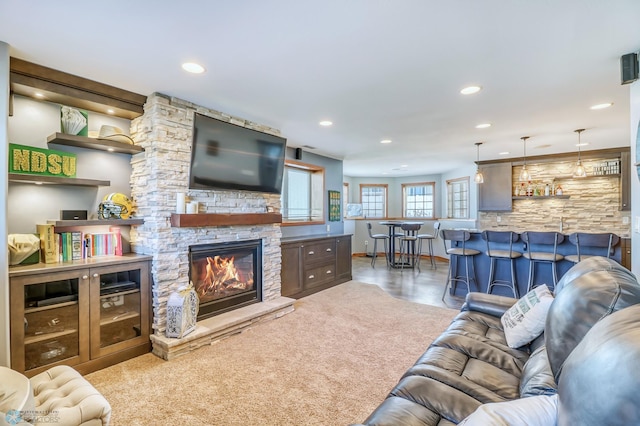 living room featuring a stone fireplace