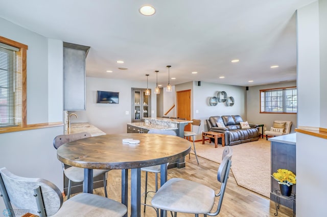 dining space featuring sink and light hardwood / wood-style flooring