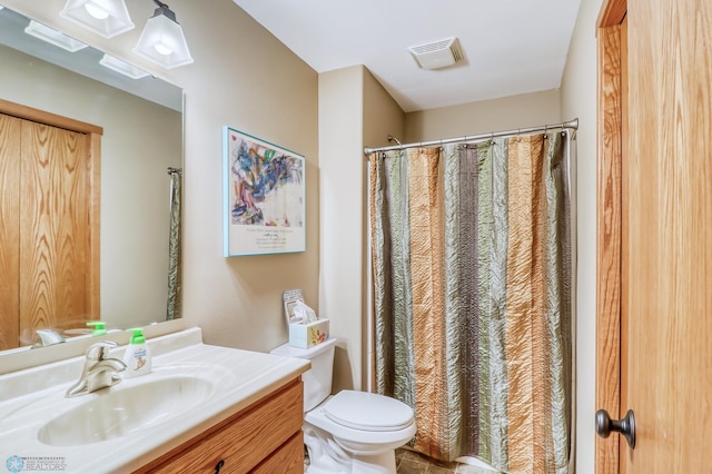 bathroom featuring vanity, toilet, and a shower with shower curtain