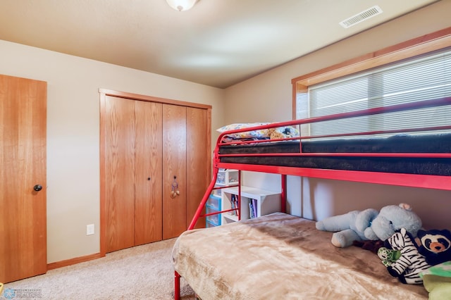 carpeted bedroom with a closet