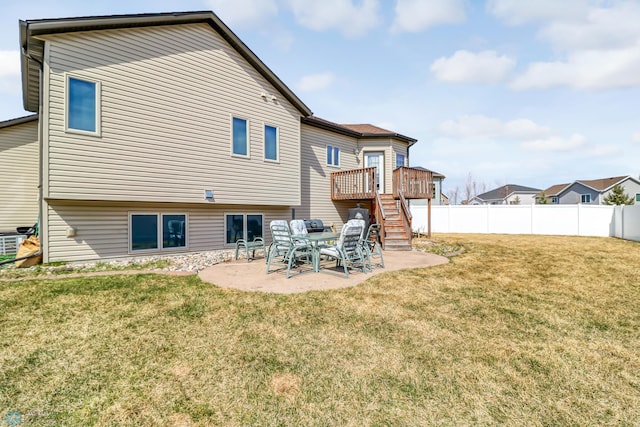 back of property with a lawn and a patio