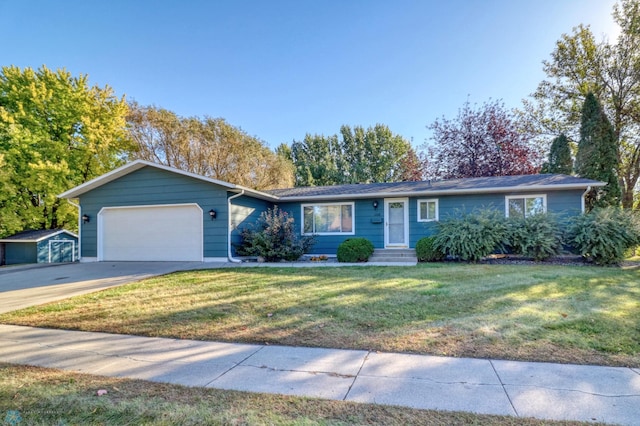 ranch-style home with a garage and a front lawn