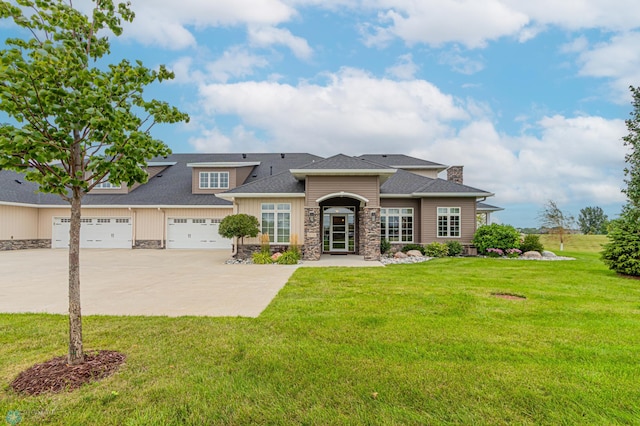 prairie-style house featuring a front yard and a garage