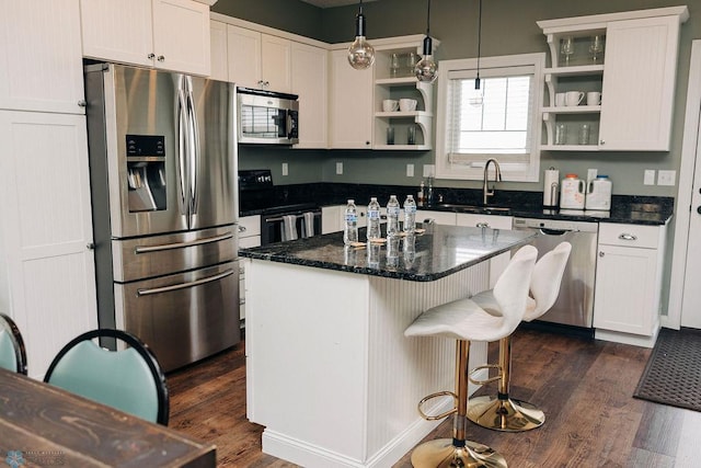 kitchen featuring stainless steel appliances, white cabinetry, and dark hardwood / wood-style flooring