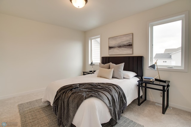 carpeted bedroom with multiple windows