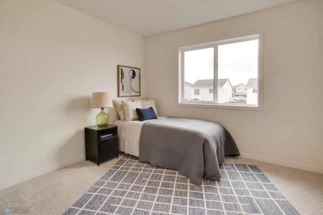 bedroom featuring light carpet