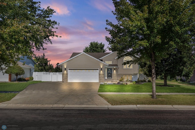 view of front facade with a lawn and a garage