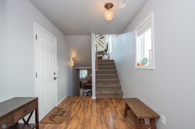 stairway with hardwood / wood-style floors