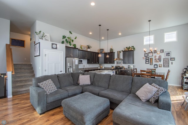 living room featuring a chandelier, hardwood / wood-style flooring, and sink