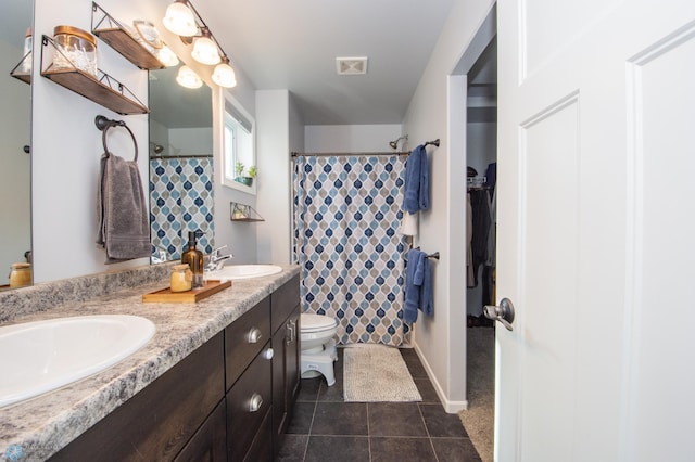 bathroom with tile patterned flooring, a shower with curtain, vanity, and toilet