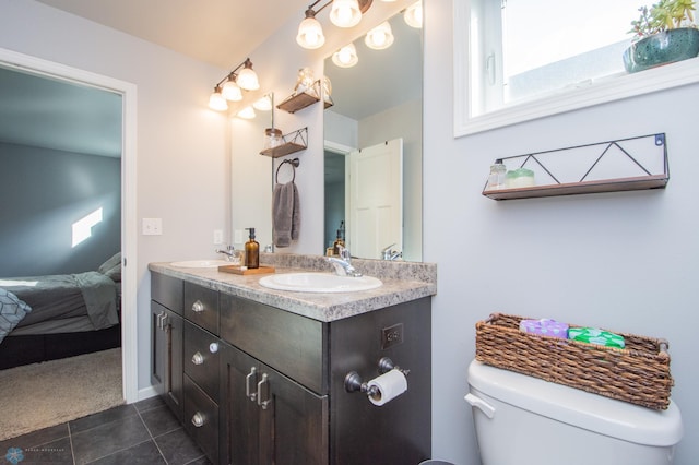 bathroom with tile patterned floors, vanity, and toilet