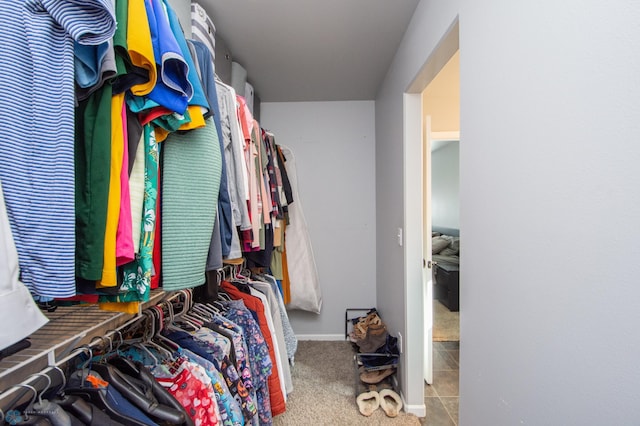 walk in closet with light tile patterned floors