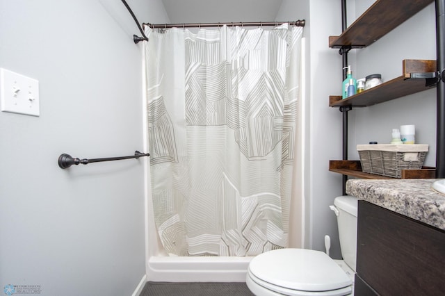 bathroom with walk in shower, vanity, and toilet