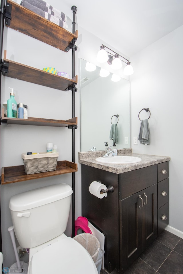 bathroom with vanity, toilet, and tile patterned floors