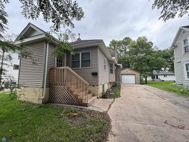 view of front of house featuring a front yard, a garage, and an outdoor structure