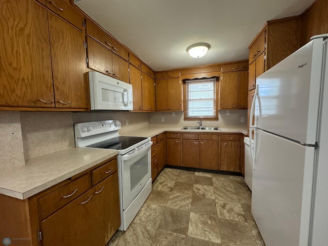 kitchen featuring decorative backsplash, white appliances, and sink