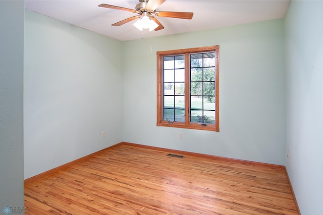 unfurnished room with light wood-type flooring and ceiling fan