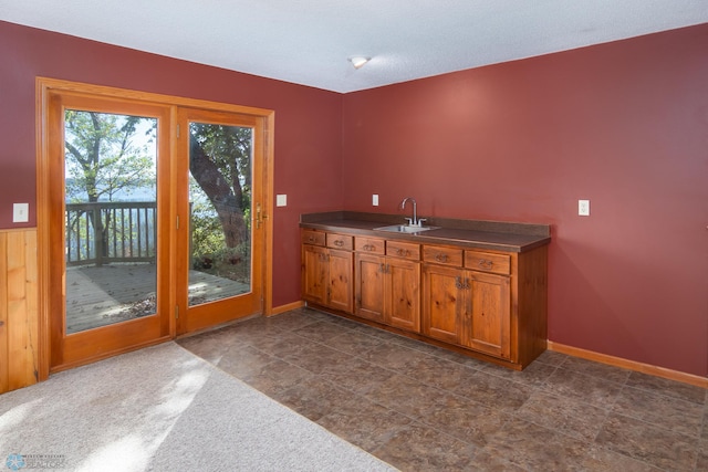 kitchen featuring a textured ceiling and sink