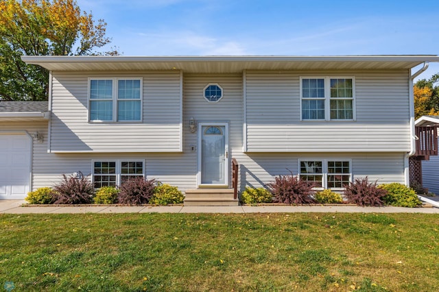 split foyer home with a front yard and a garage